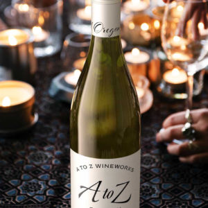A to Z Chardonnay on table with lots of candles and one glass