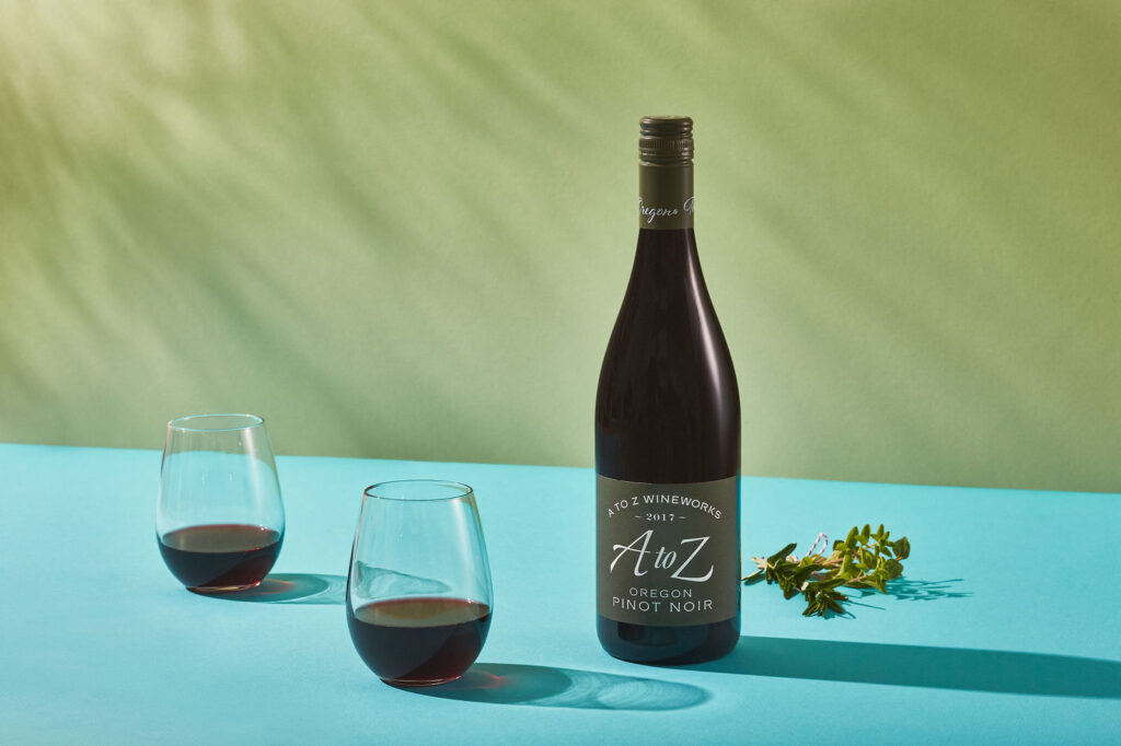 A to Z Pinot Noir on color block background with stemless glasses