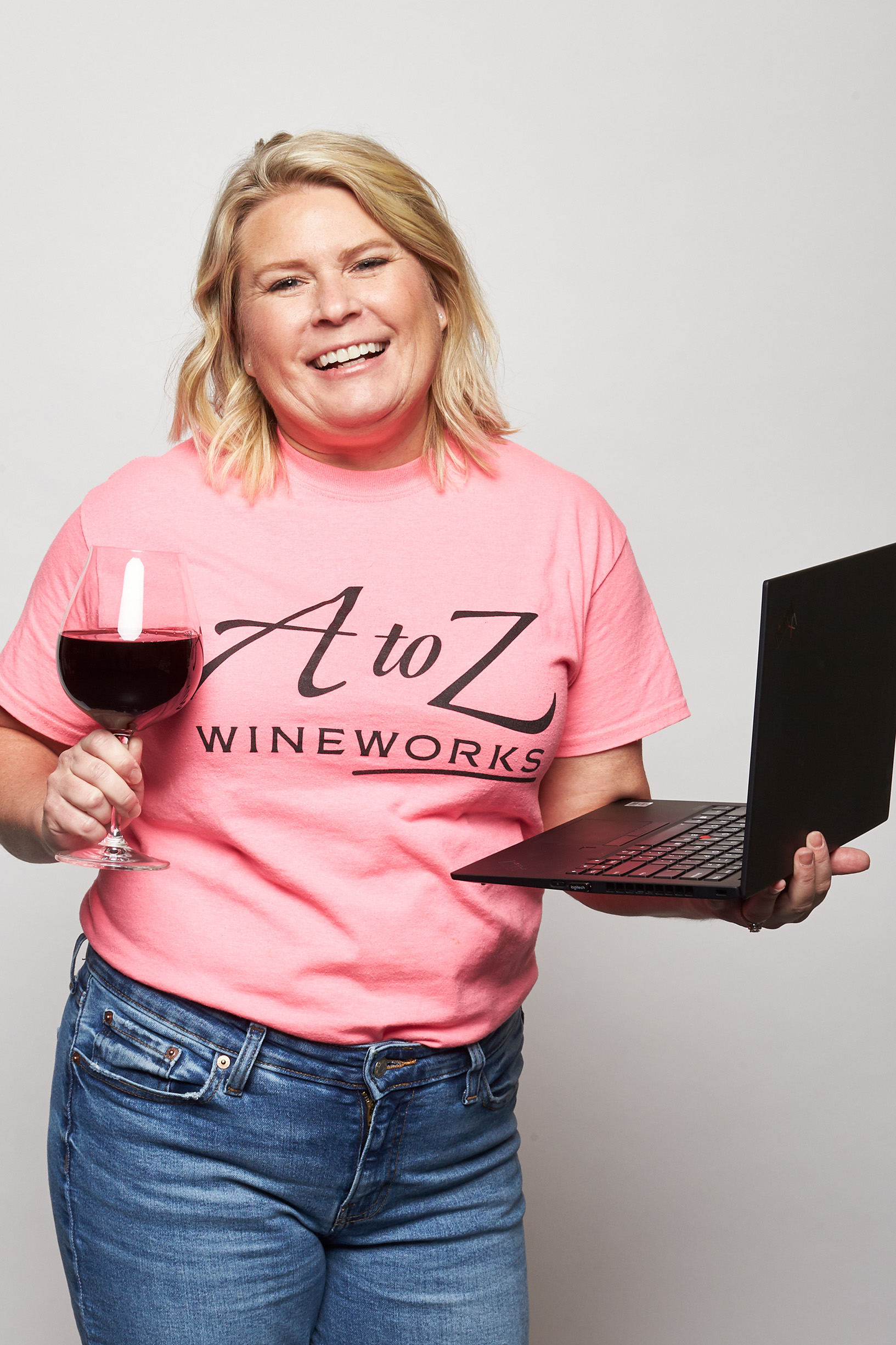 Kelly holding wine and laptop