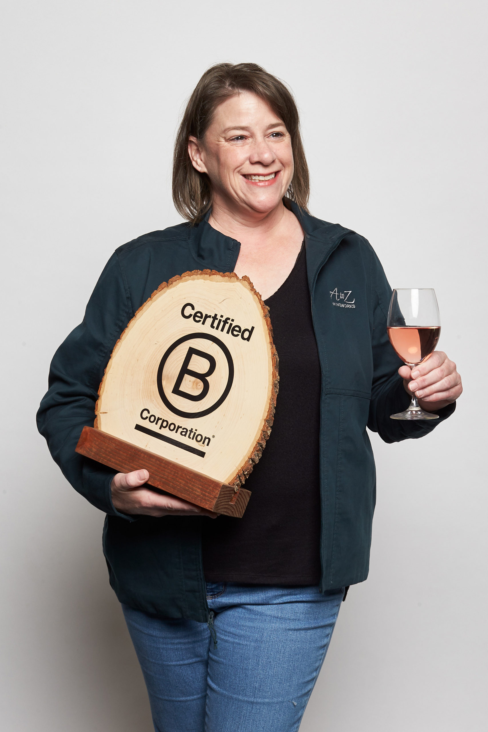 Michelle holding b corp sign and wine glass WAAZ