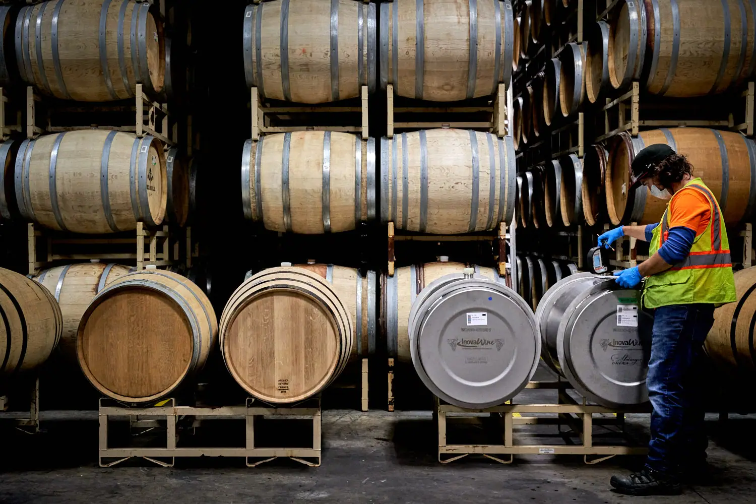 Employee checking on wine
